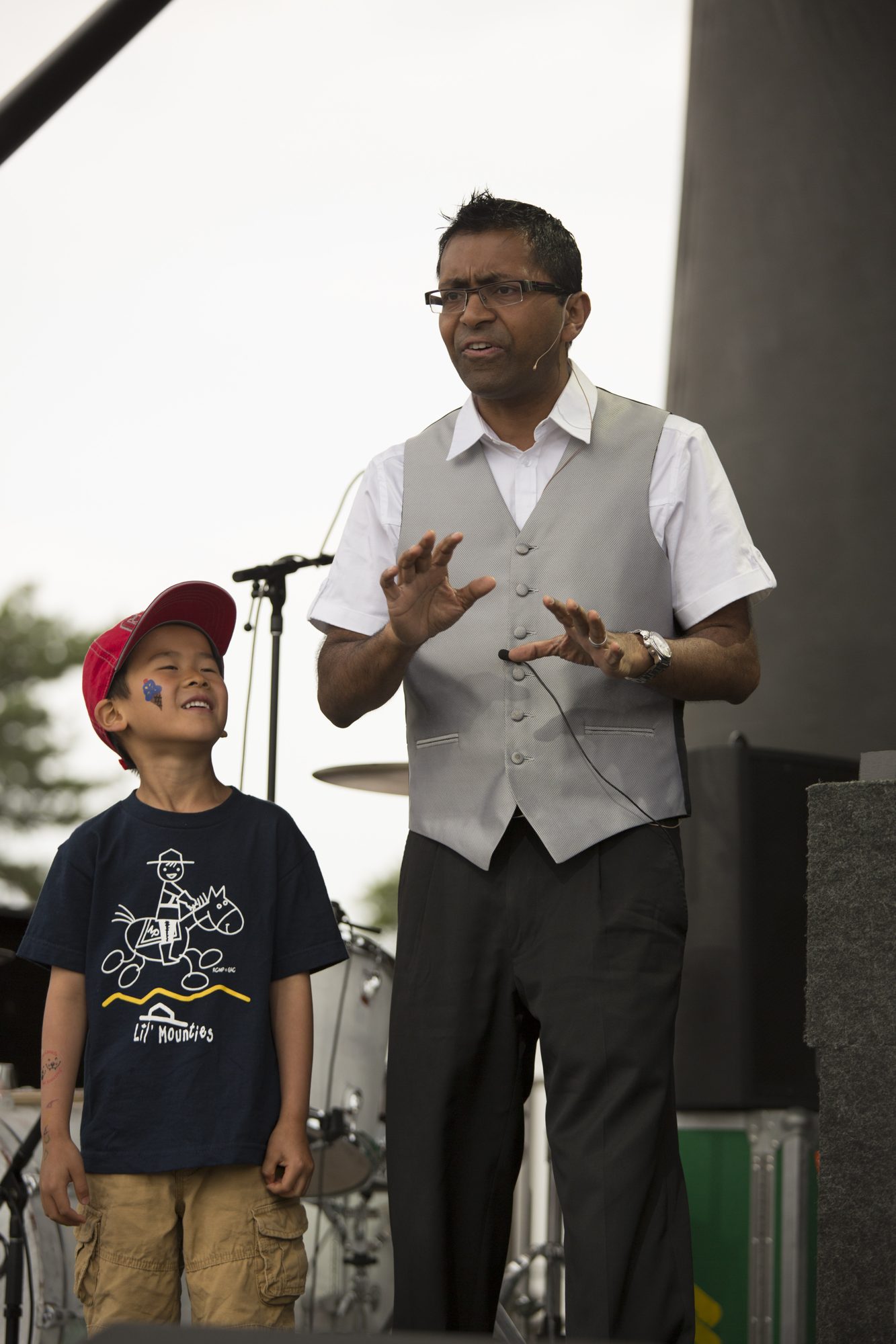 Wij on stage at a large outdoor assembly